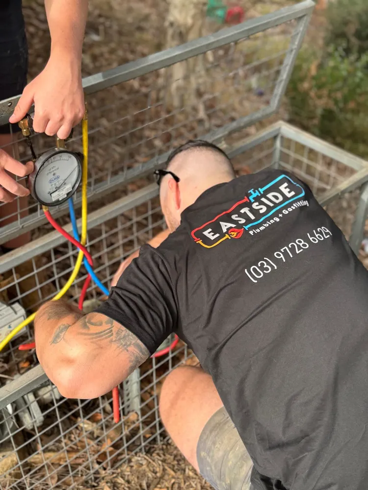 Eastside technician using pressure gauges on a job